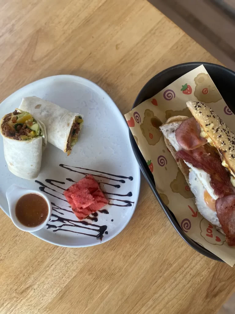 Spicy sausage wrap with tomato relish and a bacon, egg and tomato roll at Poached Breakfast Cafe Rawai: a fantastic breakfast before heading out on one of the island tours in Rawai.